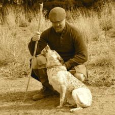 The author with his antler-fork walking stick and his dog begging for a walk.